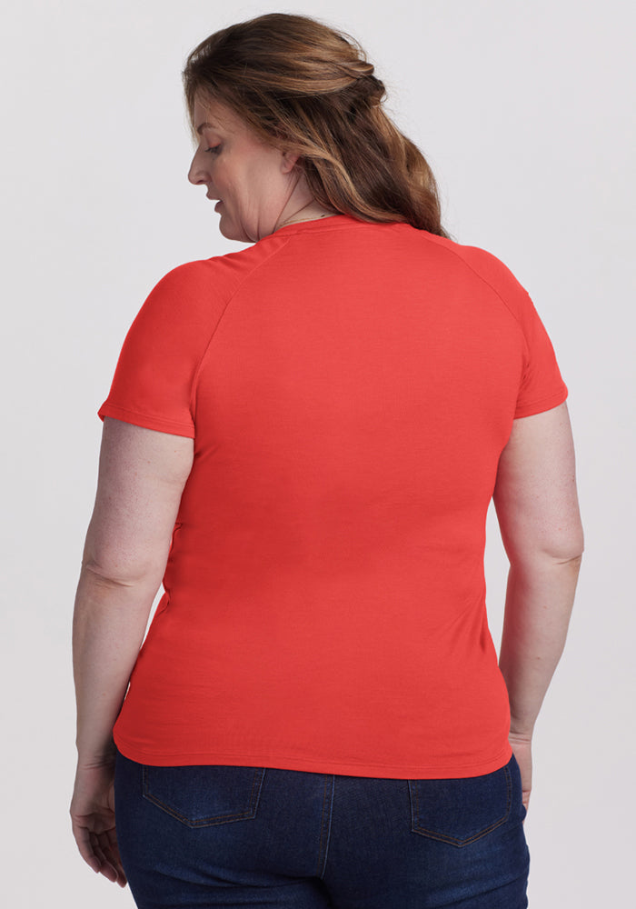 Woman with long brown hair wears the Woolx Mia V Neck - Hibiscus, shown from the back against a plain background.