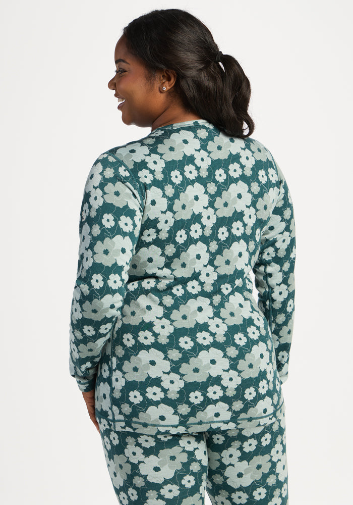 Woman in Woolx Maddie Baselayer Top - Coastal Wildflower, facing away, smiling over her shoulder.