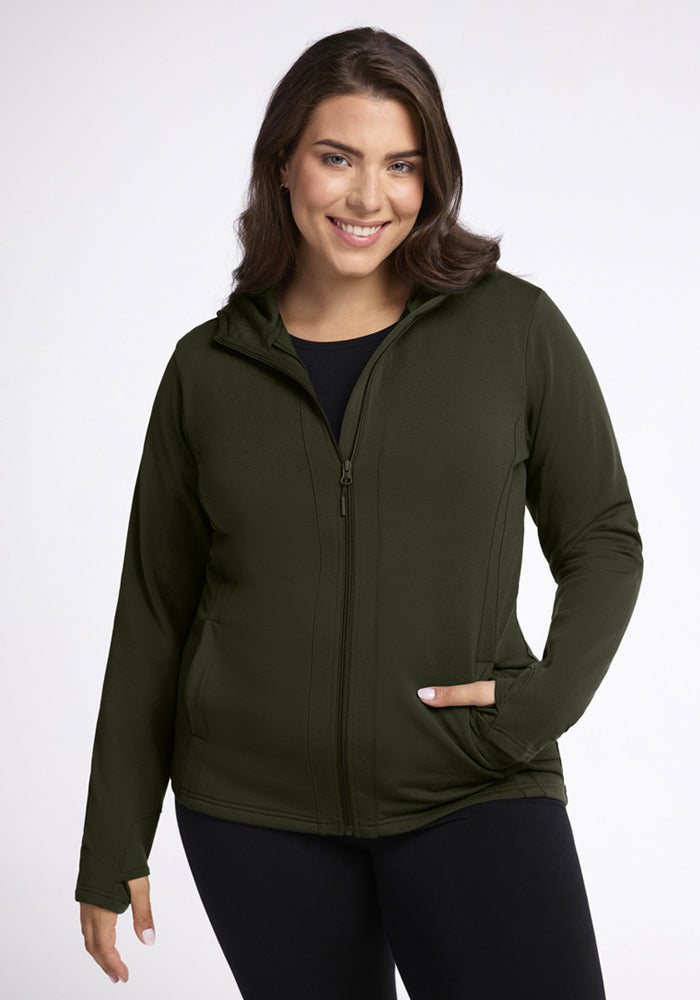 Woman smiling in Woolx Zoey Zip Up Hoodie - Duffel Bag with black pants, against a plain white background. 