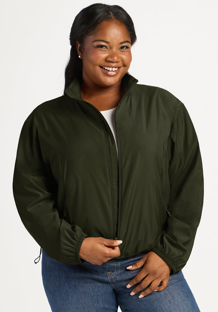 A smiling woman wearing a dark green, zip-front Cooper Windbreaker - Duffel Bag. 