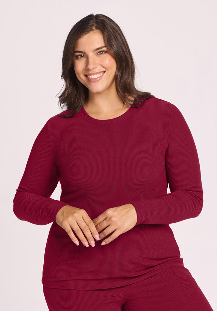 Woman with medium brown hair in Woolx Hadley Ribbed Crew - Beet Red, smiling warmly at the camera. 