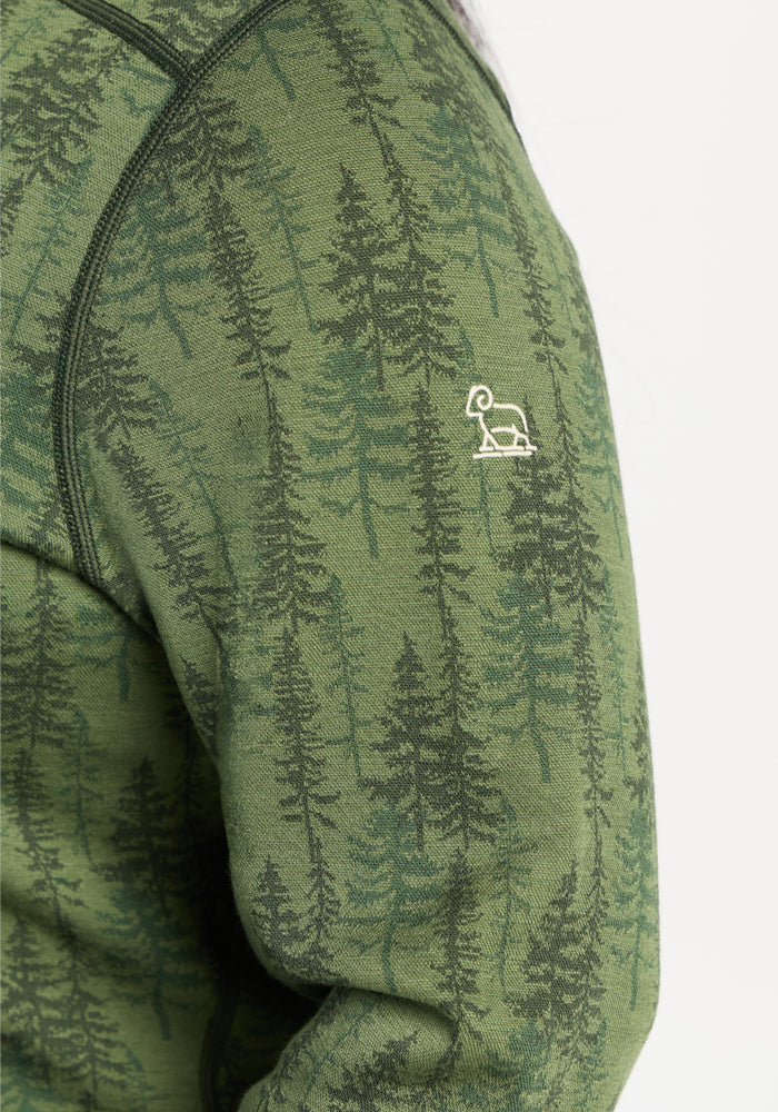 Woolx Emi 1/4 Zip - Forest Friends: Merino base layer with dark green tree print and white ram logo for winter warmth.