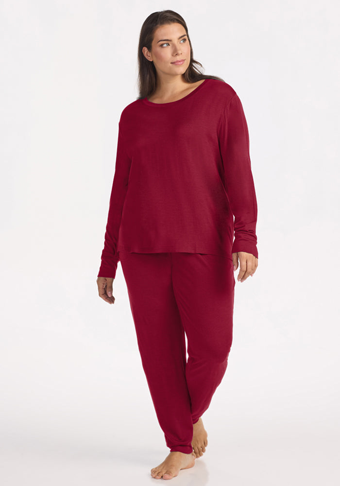 Woman wearing an Ashlie Lounge Top in beet red with matching wrinkle-resistant, long-sleeved, jogger-style pants.