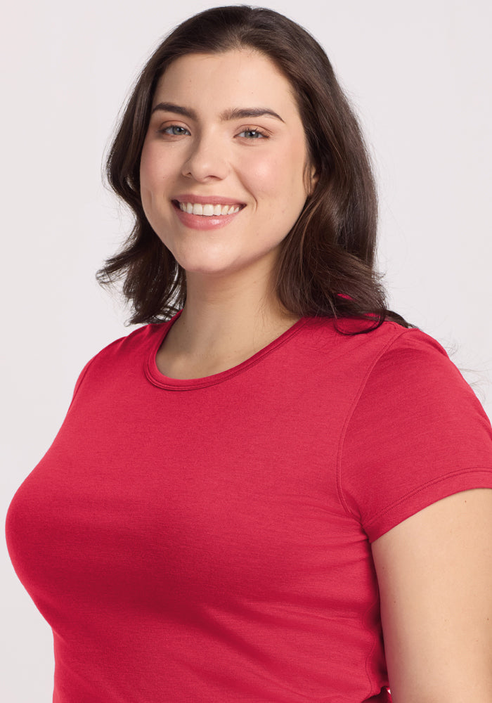 Smiling woman with long brown hair wears a Woolx Addie Crew Neck in Berry Ice Pop against a plain light background.
