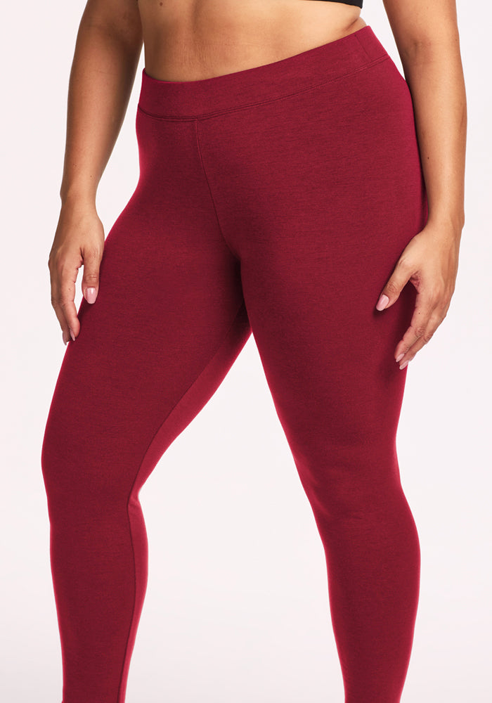 Model in Woolx Stella Leggings - Pinot Noir, high-waisted Merino wool, fitted for a flattering look on a light backdrop.