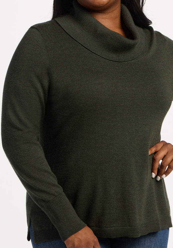 Woman in Woolx Josie Cowl Neck Sweater - Duffel Bag, with blue jeans, hand on hip.