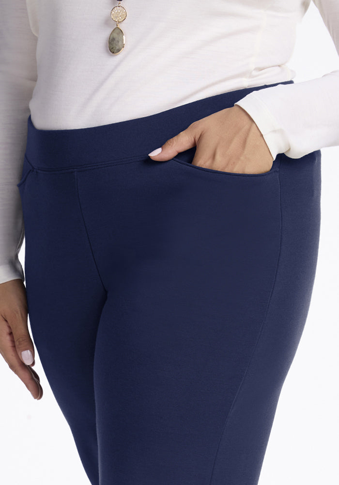 Person wearing Woolx Ellie Wide Leg Pants in Ocean Cavern and a white top, with one hand in their pocket.