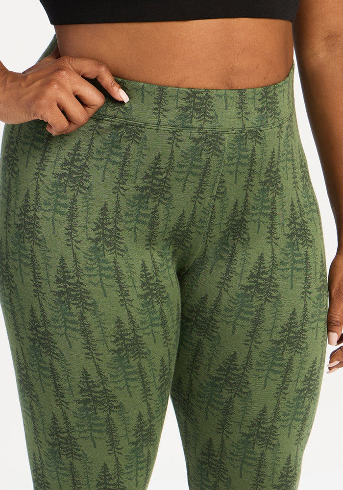 Close-up of a person in Woolx Taylor Baselayer Leggings - Forest Friends, hand on hip.