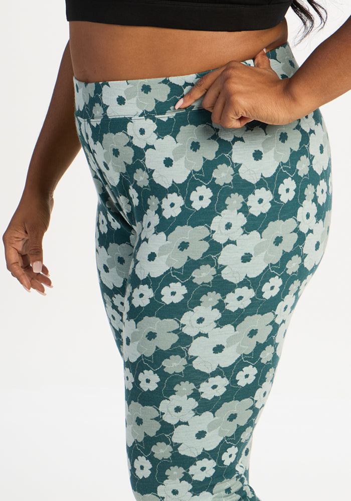 Model in Woolx Taylor Baselayer Leggings - Coastal Wildflower and black top, posing hand on hip against white background.