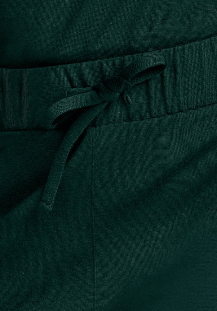 Mary Kate Lounge Pants - Deep Pine in dark green, featuring moisture-wicking fabric, an elastic waistband, and a drawstring.