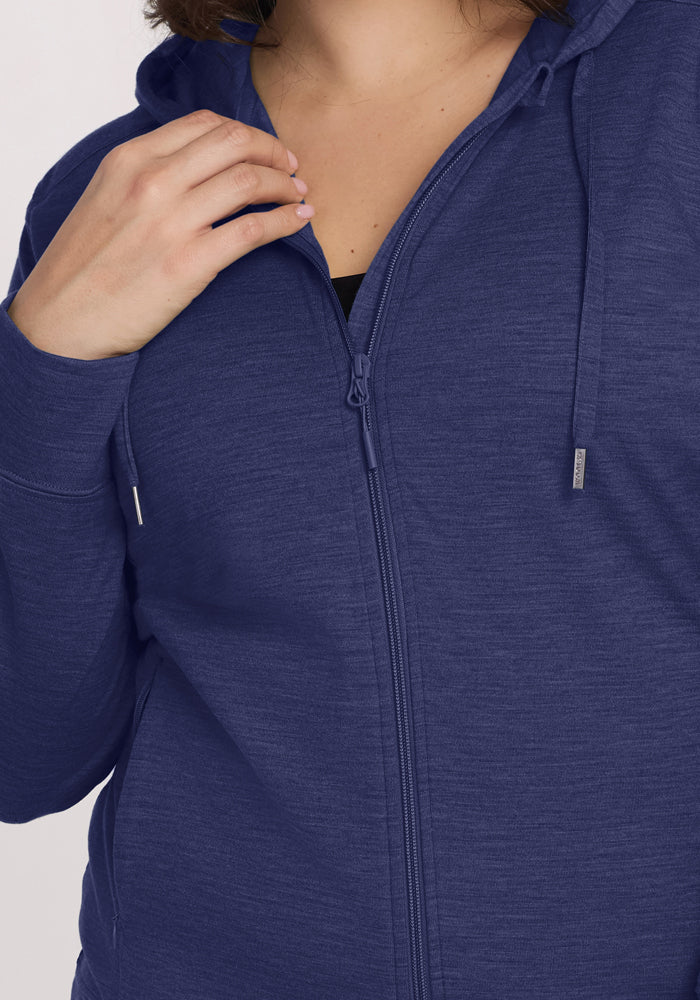 A person in the Woolx Ryann Hoodie - Twilight Storm holds the collar by their neck with one hand.