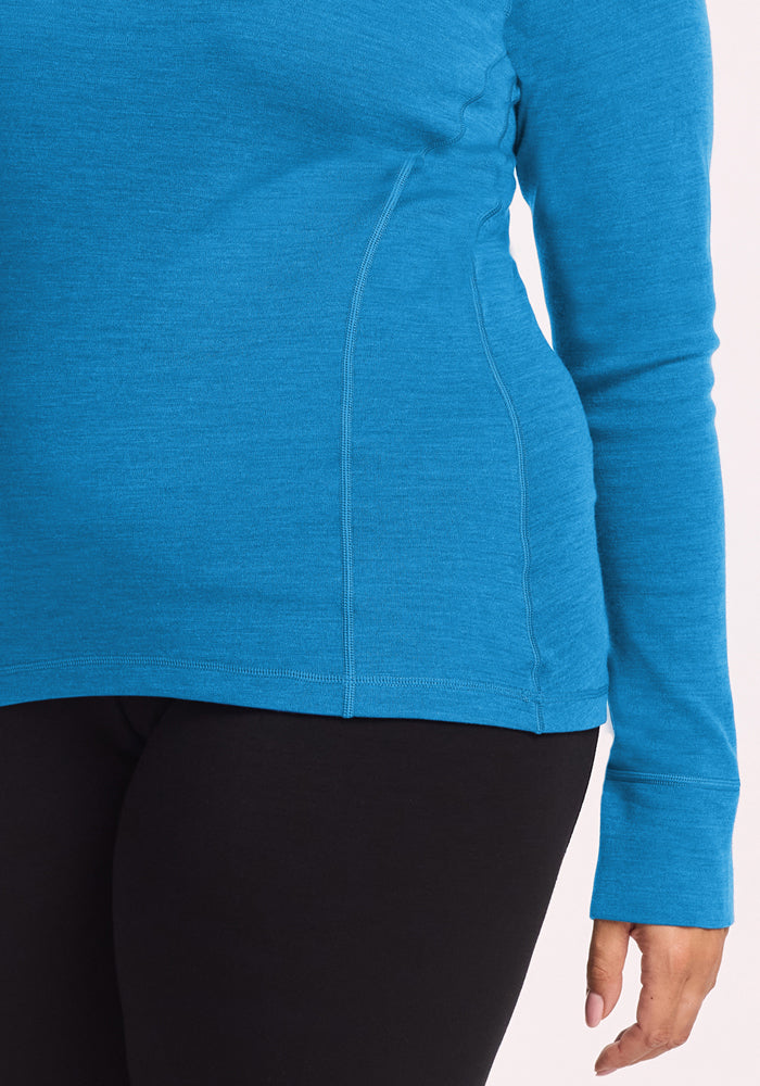 Model in Woolx Hannah Long Sleeve Top - Blue Razz and black pants, shown chest to thigh, arm at side.