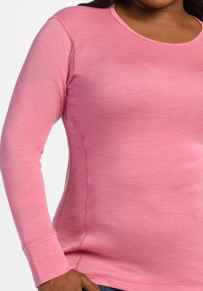 Model wears Woolx Hannah Long Sleeve Top in Pinky Promise, neck to hip view with one hand shown.