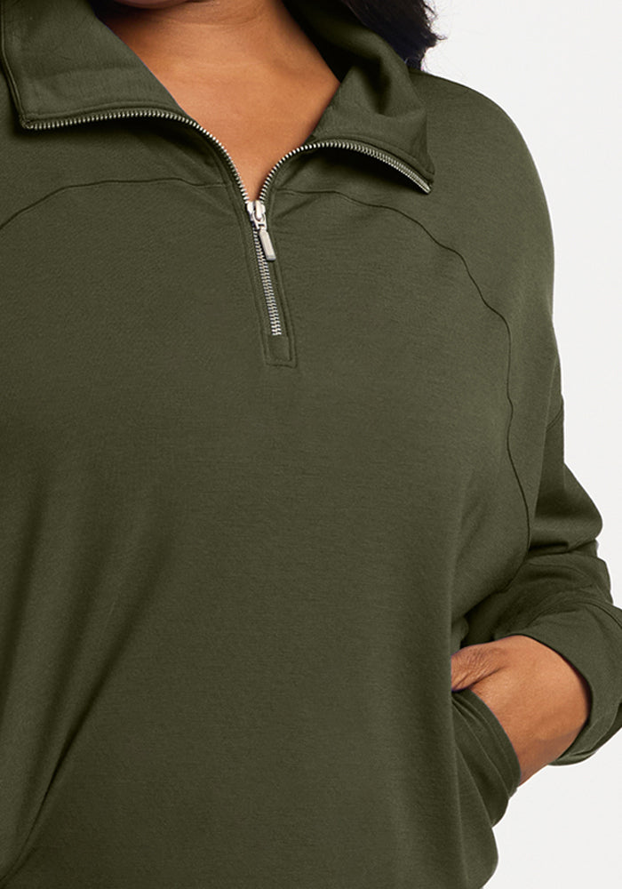 Olive green lightweight Woolx Tori 1/4 Zip merino pullover with a quarter-zip collar and a front pocket.