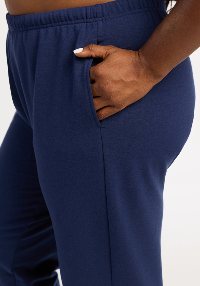 Model in Woolx Juliette Joggers - Ocean Cavern, hand in pocket, close-up shows hip and waist details.