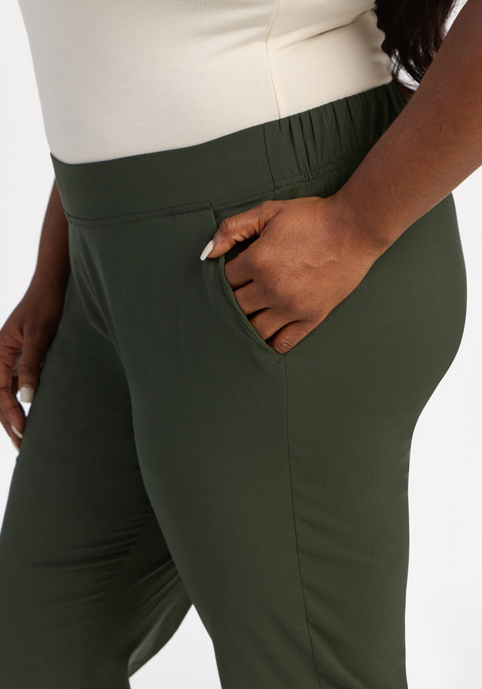 Model wears Woolx Nicole Ankle Pants in Duffel Bag with a cream top, one hand casually in the pocket.