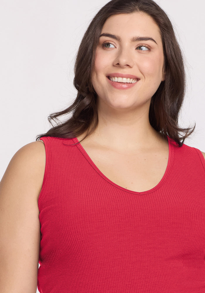Smiling woman in Woolx Vivi Ribbed Tank - Berry Ice Pop, looking off to the side.