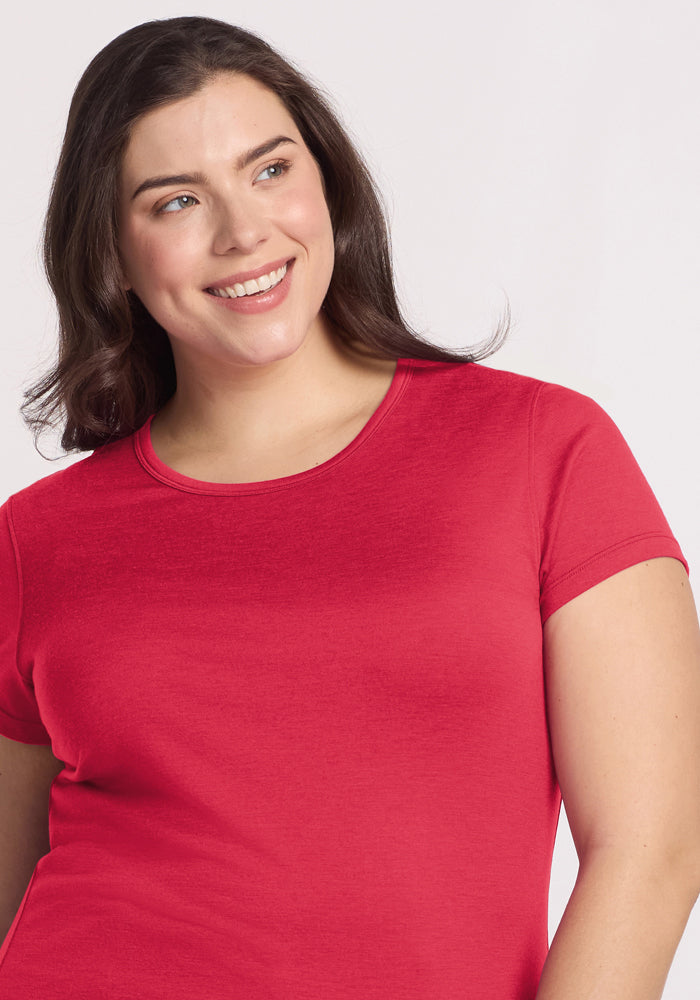 Smiling woman in the Woolx Addie Crew Neck - Berry Ice Pop, with long brown hair, looking slightly to the side.