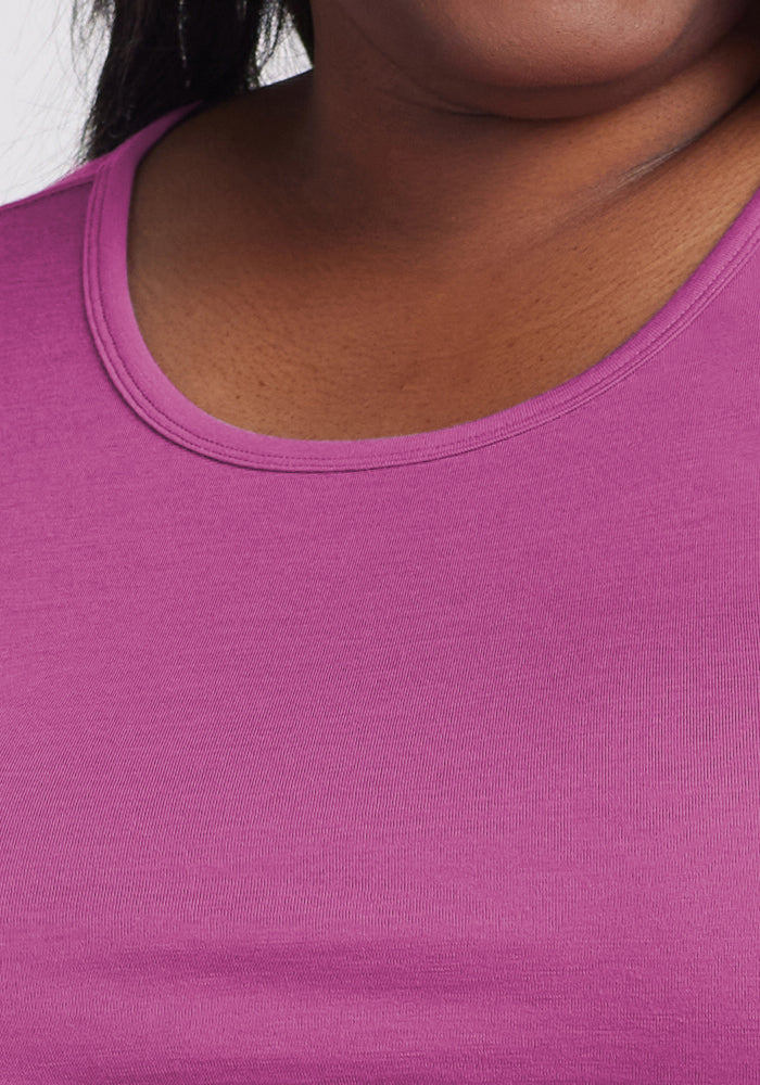 A close-up showing the neck and upper chest of a person wearing the Woolx Remi Long Sleeve T-Shirt in Purple Wine, with its smooth, moisture-wicking fabric visible against a plain background.