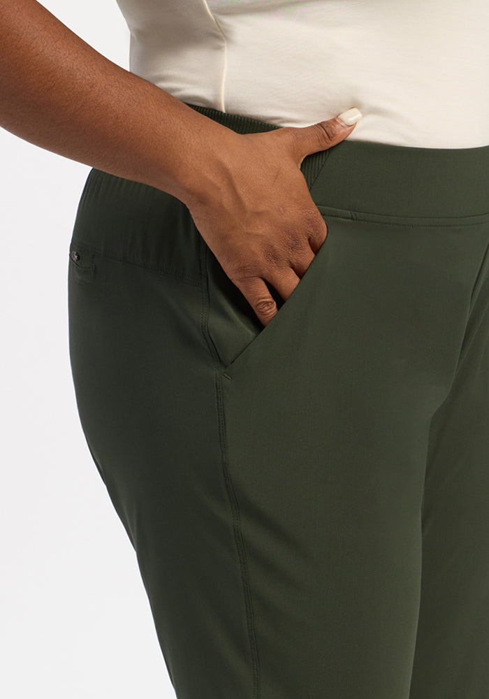A person in a cream shirt and Woolx Palmer Joggers - Duffel Bag stands with their right hand in their pocket.