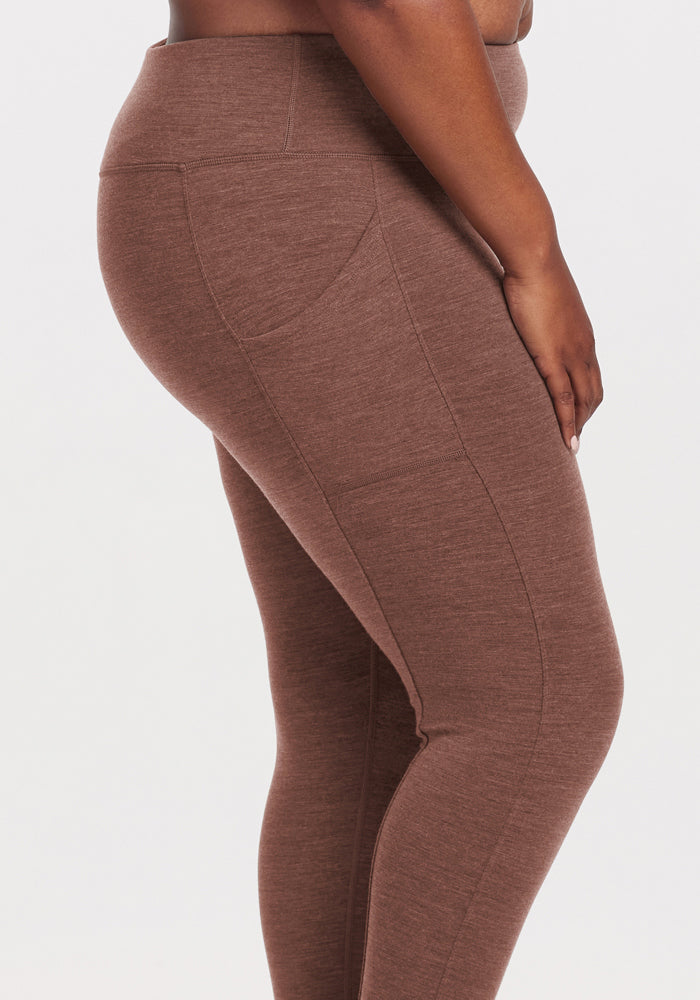 Model in Woolx Piper Pocket Leggings - Sable Heather, waist to ankles side view, against plain background.