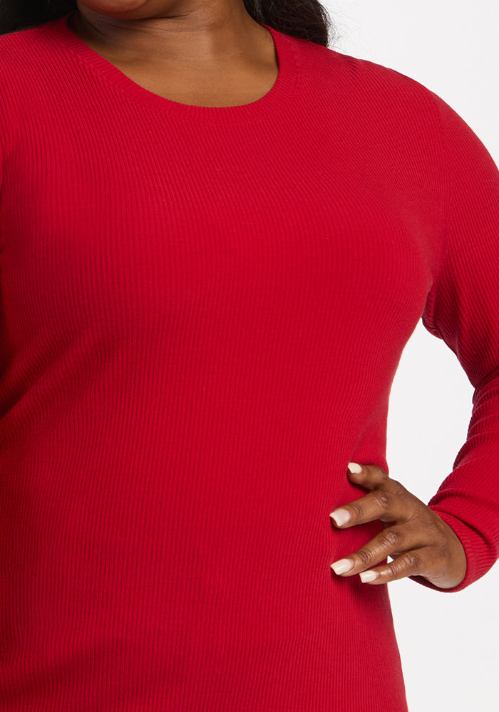 Model wears the Woolx Hadley Ribbed Crew in Maraschino Cherry, one hand on hip, standing against a plain background.