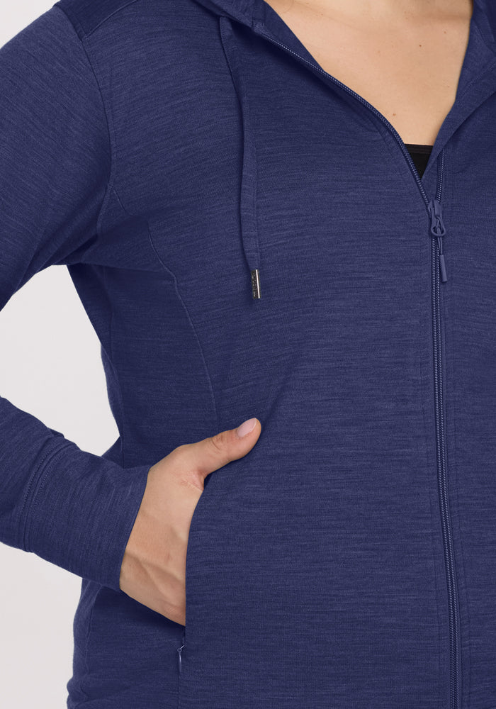Person in a Woolx Ryann Hoodie - Twilight Storm, one hand in pocket, only upper body visible.
