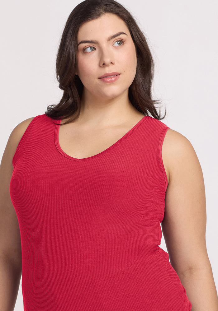 Woman with long brown hair wears the Woolx Vivi Ribbed Tank in Berry Ice Pop, looking slightly upward and to the side.