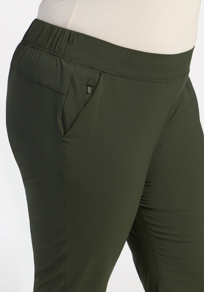 Close-up of a person wearing Woolx Nicole Ankle Pants - Duffel Bag with an elastic waist and side zippered pocket.