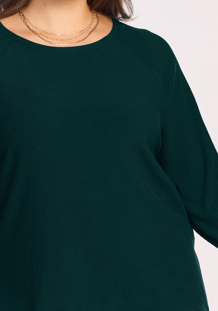 Woman wearing the Woolx Ainsley Sweater in Deep Pine with layered gold necklaces, shown shoulders to waist.