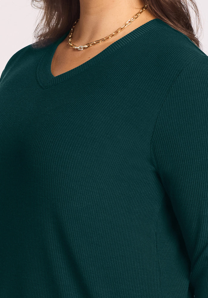Woman wearing Woolx Evie Ribbed Tunic in Deep Pine with a gold chain necklace, shown shoulders to chest.