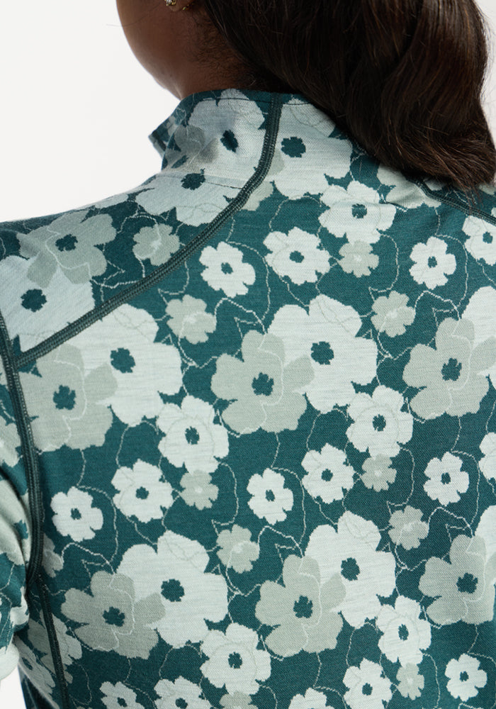 Close-up of Woolx Emi 1/4 Zip - Coastal Wildflower, showing teal floral Merino wool and insulated upper back.