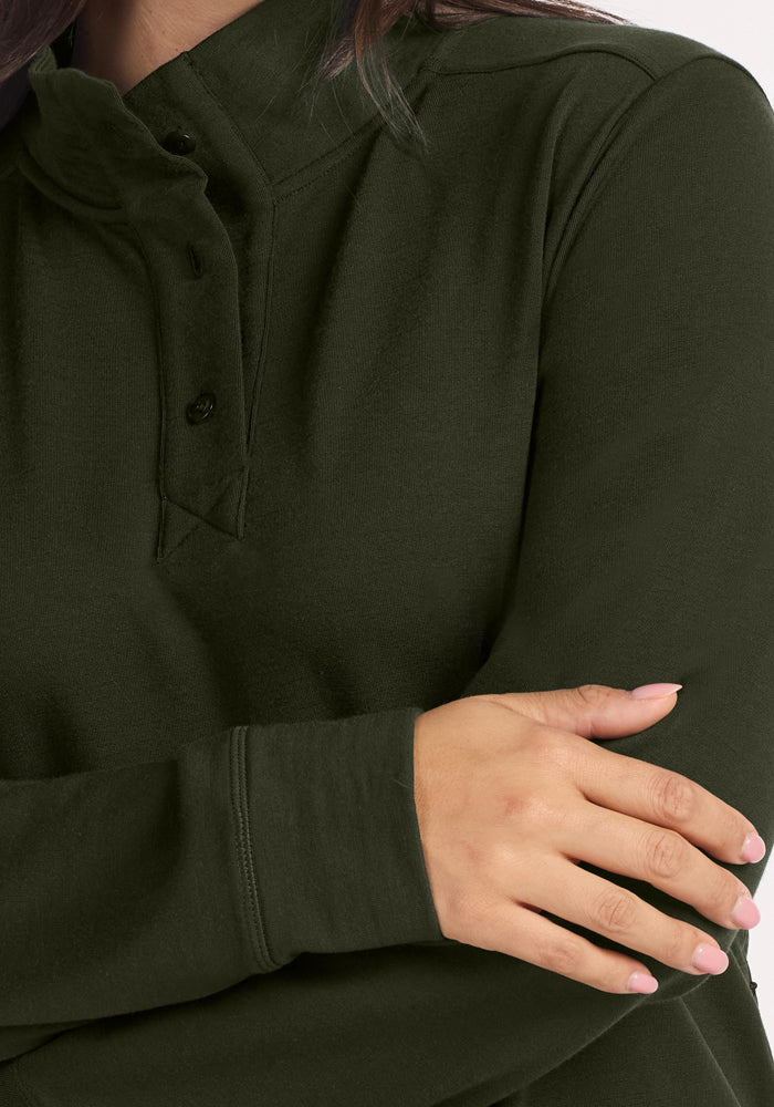Model in Woolx Annie 3 Button Pullover - Duffel Bag, arms crossed, flaunting light pink polished nails.