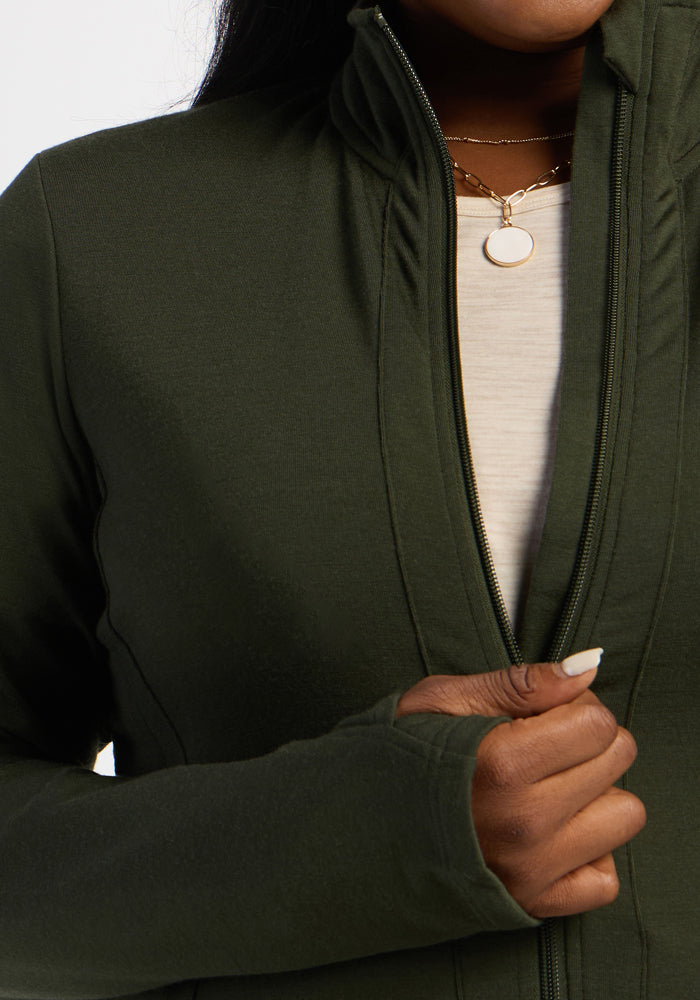 Someone zips up the Woolx Finley Zip Up Sweatshirt in Duffel Bag, revealing a white shirt and gold pendant.
