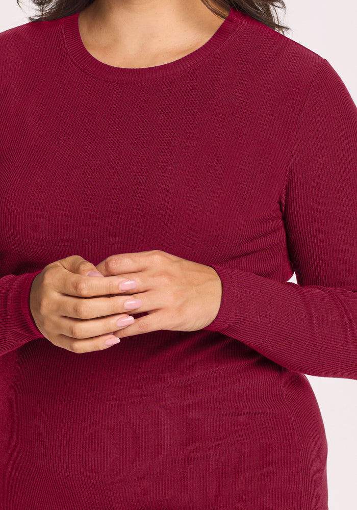 Woman in Woolx Hadley Ribbed Crew - Beet Red, hands clasped, light pink nails.