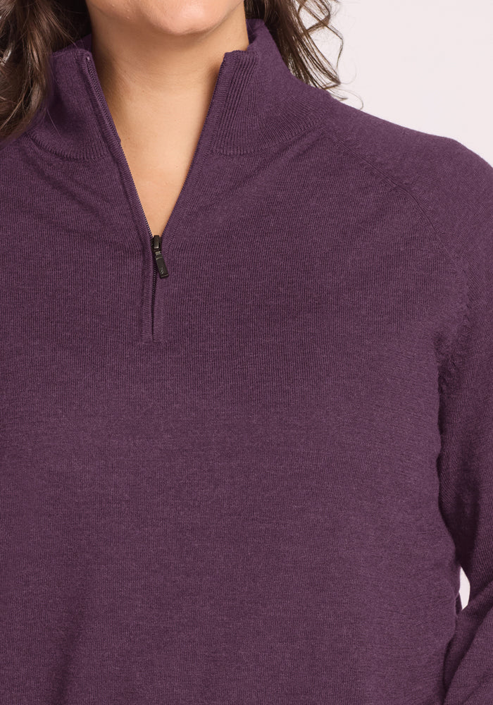 Close-up of a person in the Woolx Collins Half Zip Sweater - Purple Iris, with the zipper partially unzipped.