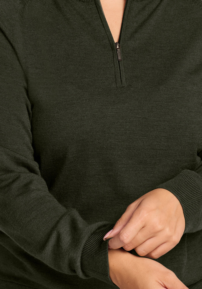 Person in a Woolx Collins Half Zip Sweater - Duffel Bag, adjusting sleeve; only torso and hands are visible.
