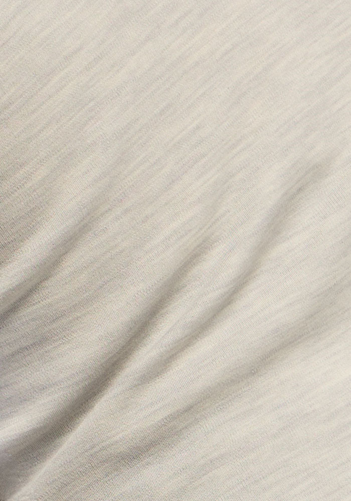 Close-up of Woolx Hannah Long Sleeve Top in Light Ash, featuring subtle lines and a soft, wavy-textured thermal fabric.