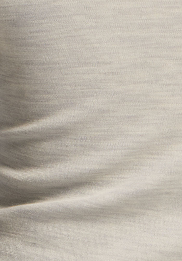 Close-up of soft, moisture-wicking light gray heathered fabric with gentle folds on a Molly Crewneck - Light Ash.