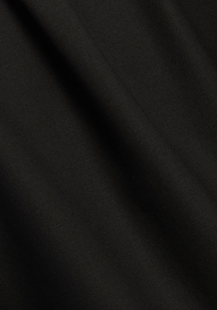 Close-up of smooth, dark Woolx Lorelai Button Up Merino wool, famed for gentle folds and temp-regulating properties.