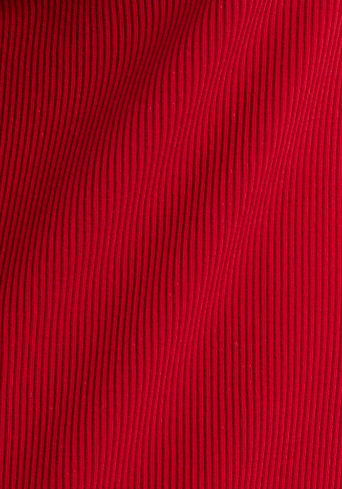 Close-up of Woolx Luca Ribbed Pants in Maraschino Cherry, featuring vertical ribbed texture and flowing curved lines.