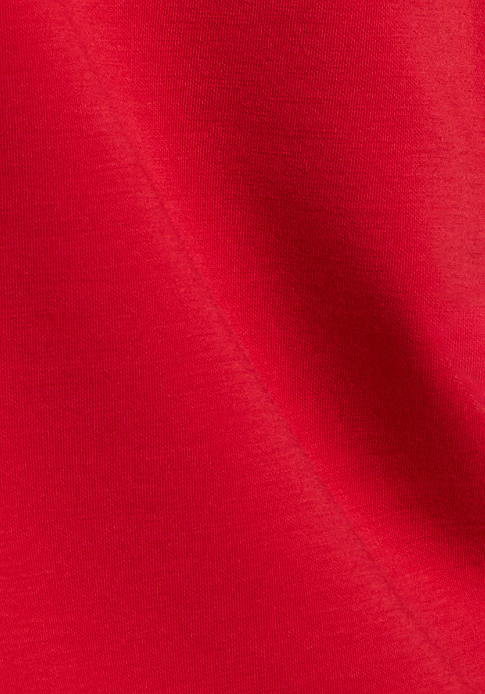 Close-up of Woolx Parker Sweatpants in Maraschino Cherry, showing textured Merino wool with a diagonal shadowed fold.