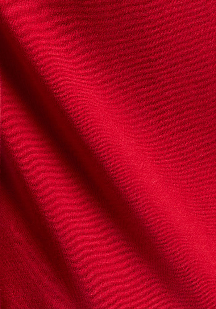 Close-up of Woolx Piper Pocket Leggings in Maraschino Cherry, with moisture-wicking texture and bold diagonal lines.