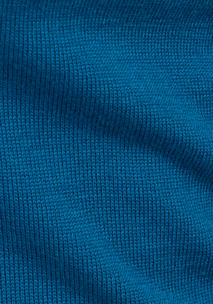 Close-up of the Anna Crew Sweater by Woolx in Moroccan Blue, featuring fine, even stitches and soft merino wool texture that highlights its flexibility and comfort.