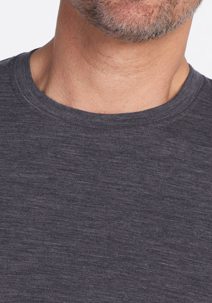 Close-up of the lower face and neck of a man with light skin and a short gray beard, wearing the Woolx Endurance Tee in Cinder Melange.