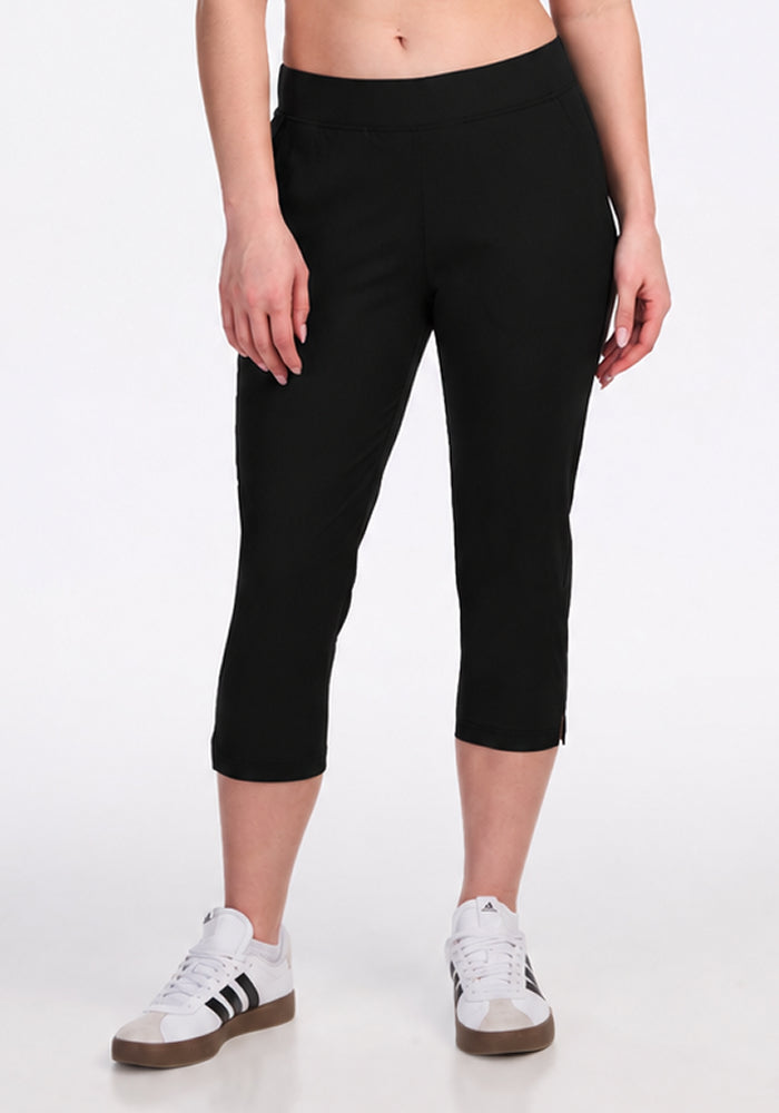Model wears Woolx Nicole Crop - Black pants with white sneakers, standing against a plain white backdrop.