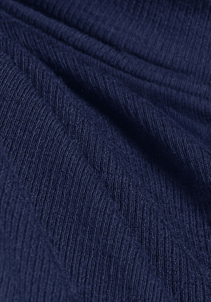Close-up of Woolx Sage Ribbed Turtleneck - Ocean Cavern, showing dark blue Merino wool with ribbed texture.