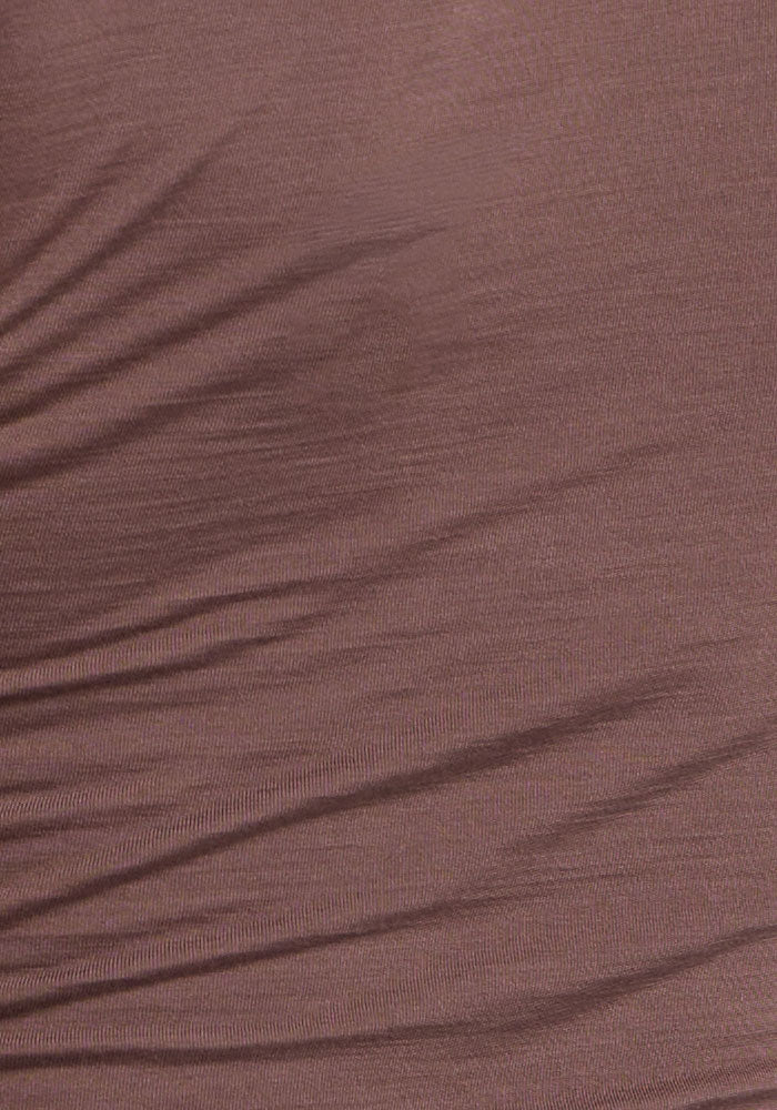 A close-up of the Woolx Gracie Bodysuit - Peppercorn shows its wrinkled, temperature-regulating merino wool fabric.