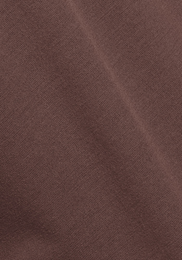 Close-up of Woolx Cassie Dress - Peppercorn showing its soft brown Merino wool fabric with a subtle diagonal crease.