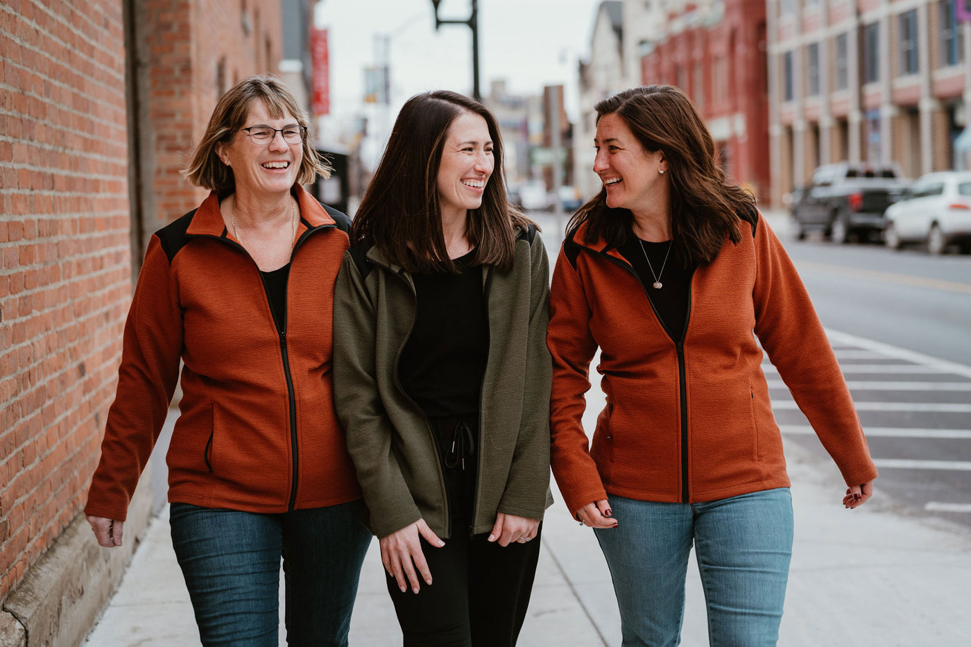 Three models wearing Peri jackets in copper and olive